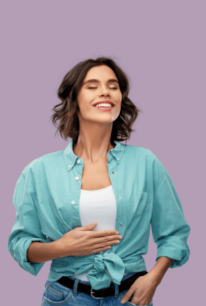 Woman with eyes closed smiling and holding her stomach, wearing a teal shirt against a light purple background.